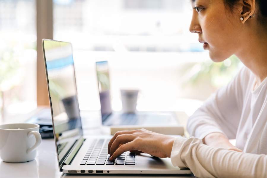 Woman browsing a home listing website with her laptop