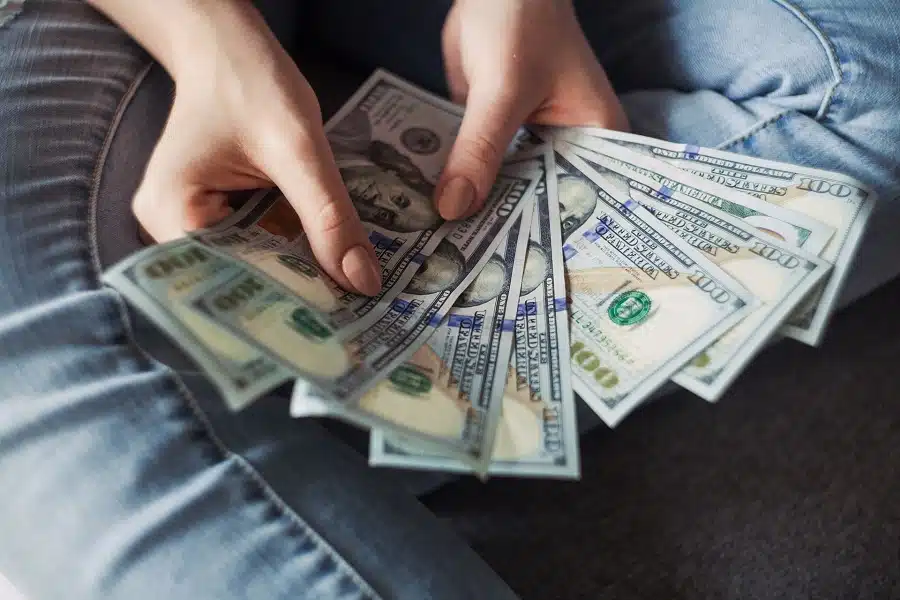 Person counting dollar bills