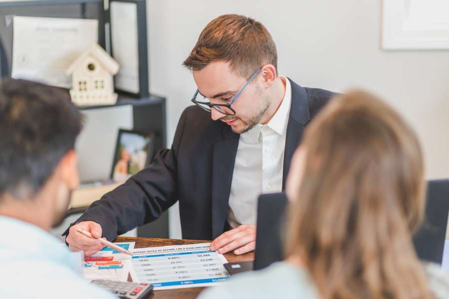 Realtor discussing about commission fees with his clients