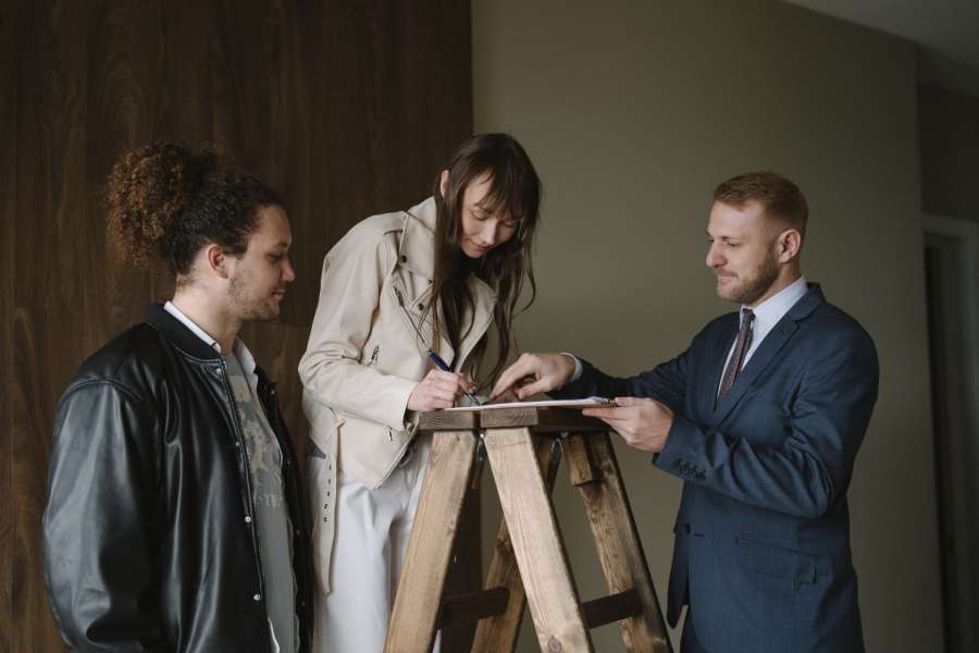 House owner signing a document after selling the house