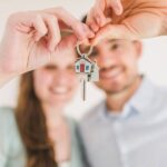 A couple both holding a house key