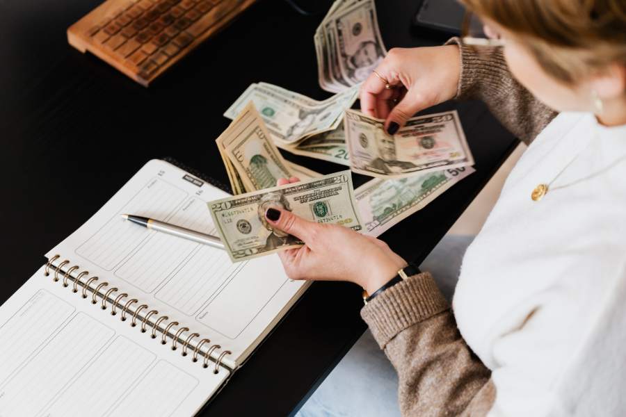 Person counting money for closing costs