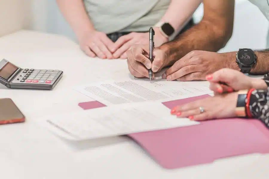 Person signing a document that relists their property on the market