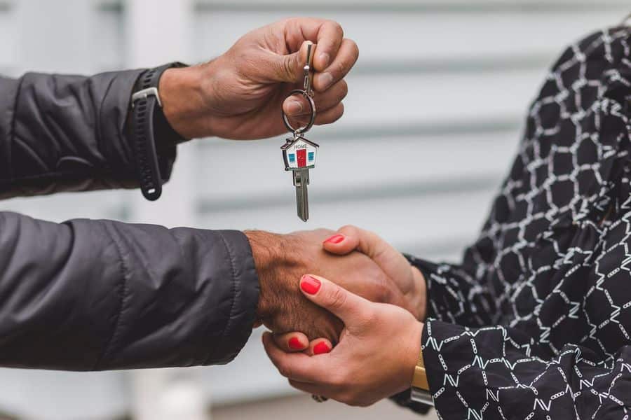 Realtor handing out the keys to the new home owner