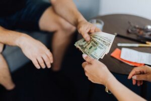 Man giving money to another person