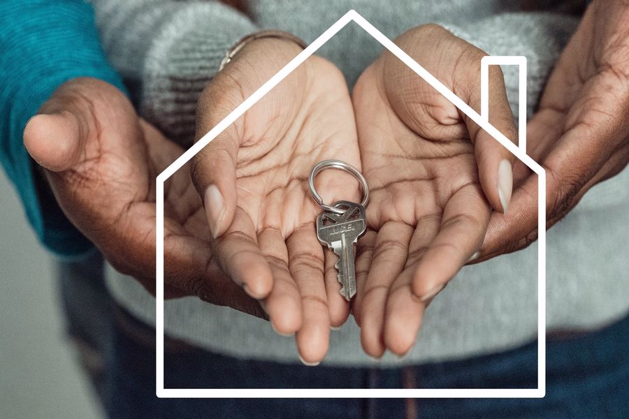 Couple holding the house keys with both their hands