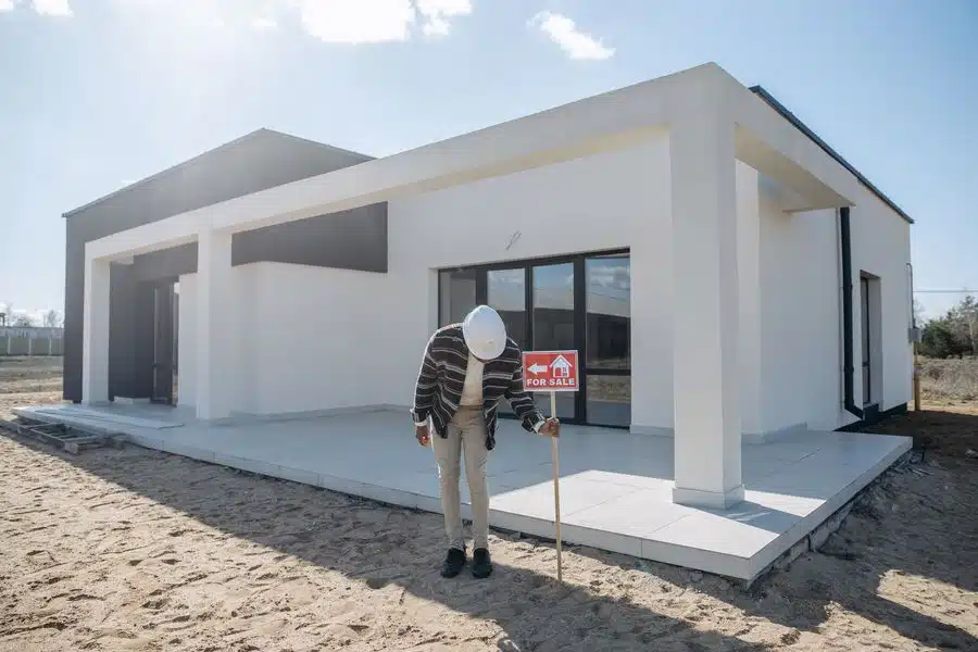 Owner putting a for sale sign in his house