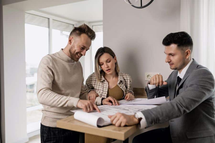 Couple looking at the floor plan with their real estate agent