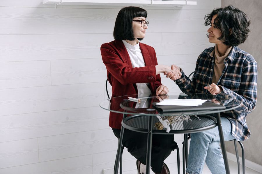 Real estate agent shaking hands with buyer after a successful transaction