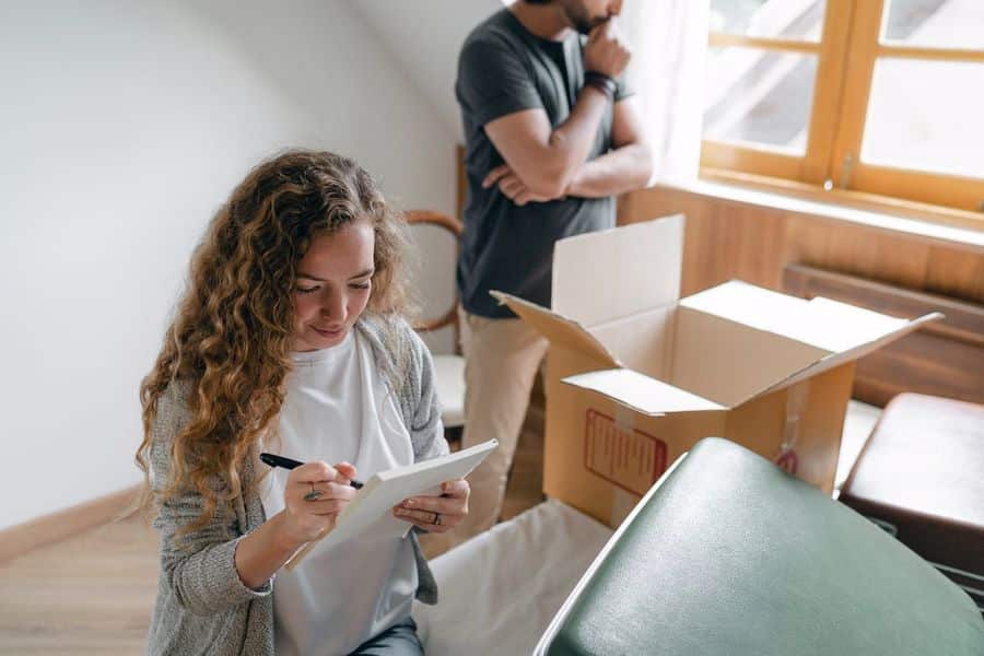 Couple packing their belongings in a box