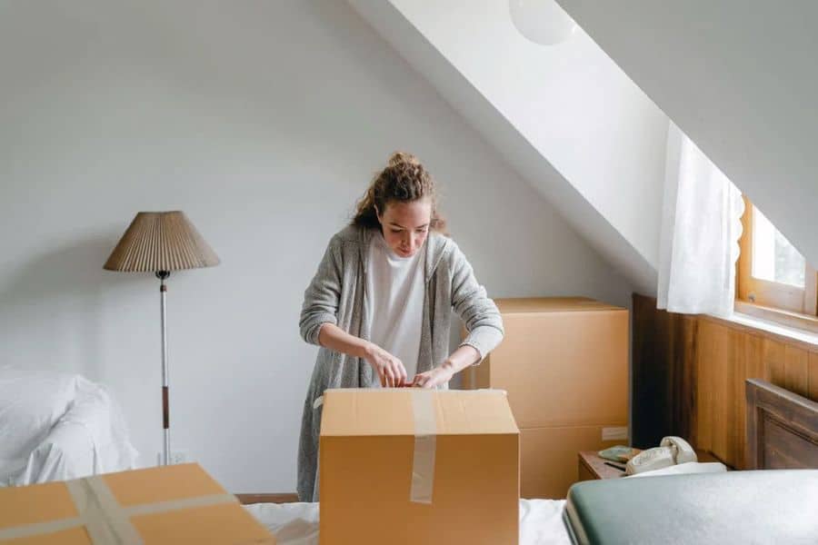 Woman packing her things before moving out