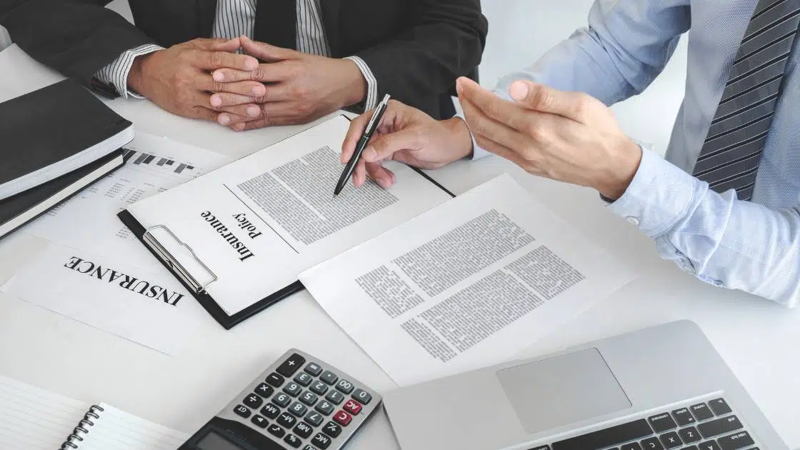two man examining a title insurance policy to calculate the cost