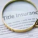 magnifying glass over a title insurance deed